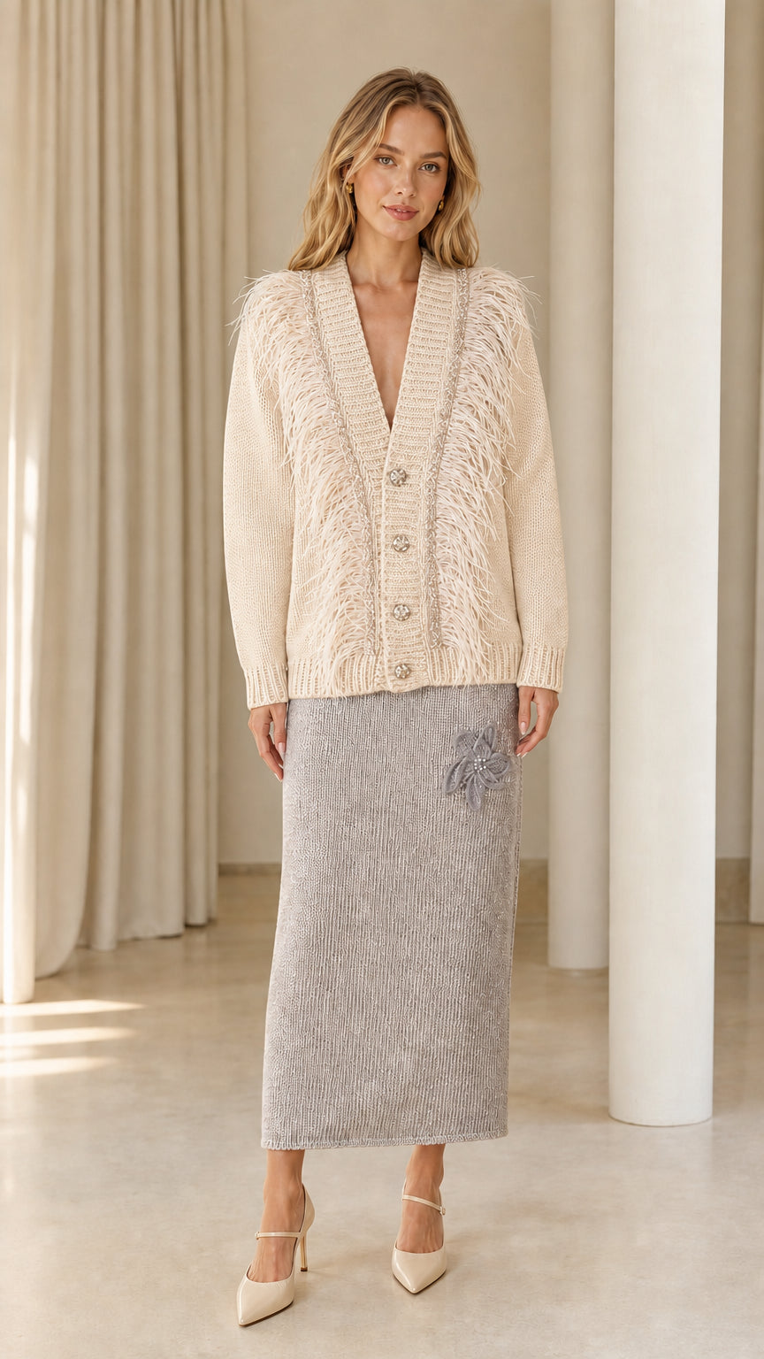 Front view of woman wearing cream off-white feather trim cardigan sweater