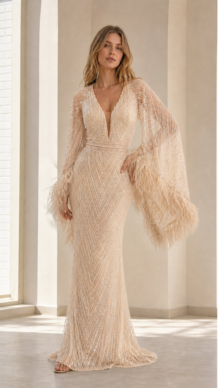 Front view of model wearing champagne gold sequin maxi evening gown with feather cuffs