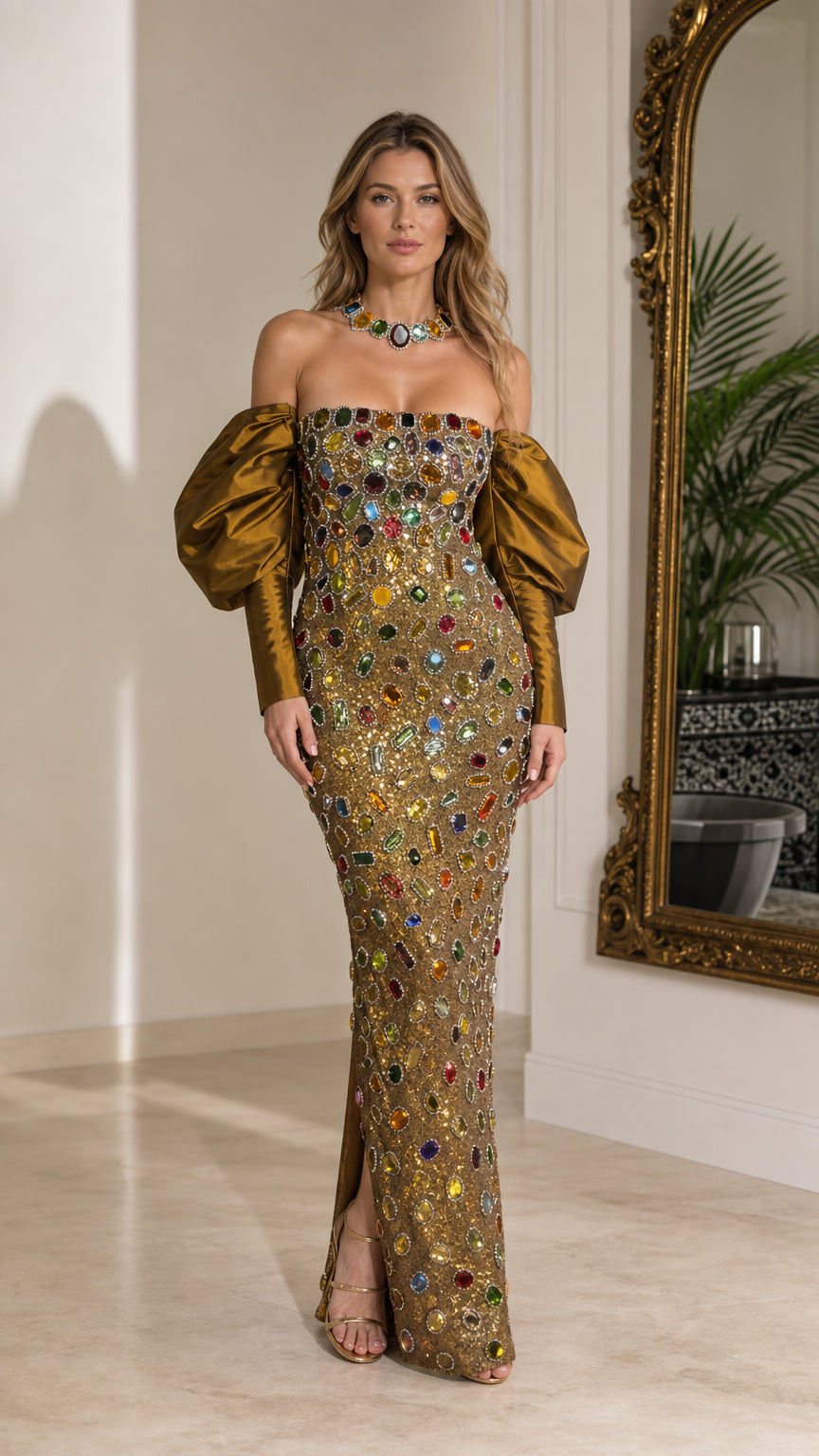 Full-length front view of woman wearing gold off-the-shoulder crystal embellished maxi gown with bronze puff sleeves