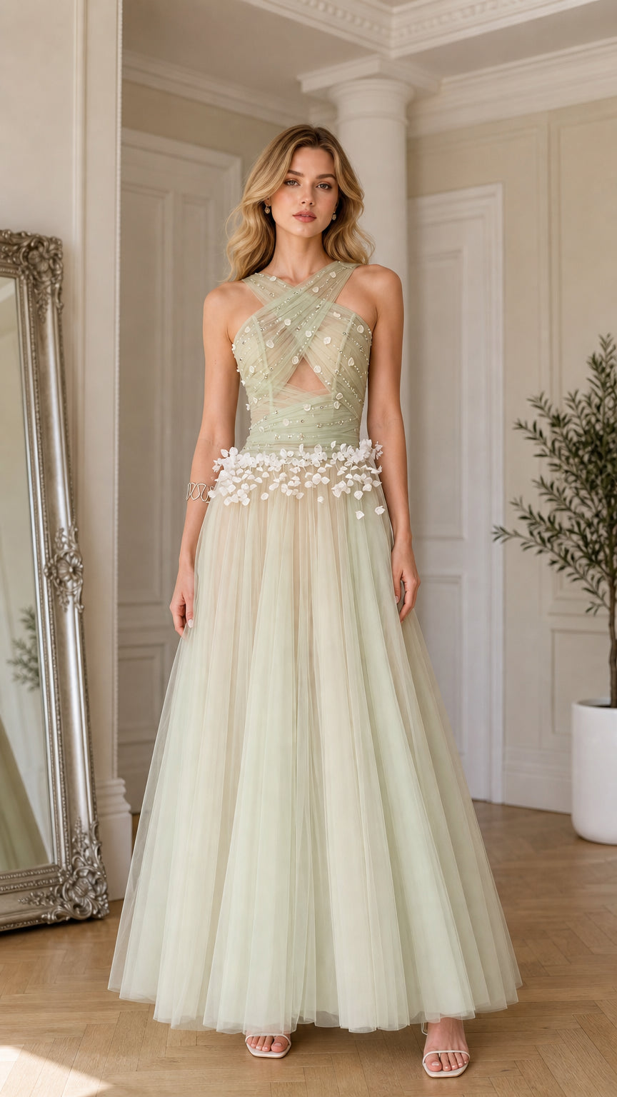 Front view of model wearing sage green criss-cross halter tulle evening gown with 3D floral accents