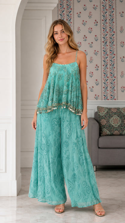Model wearing turquoise sequin embroidered cami top and wide leg palazzo pants set front view