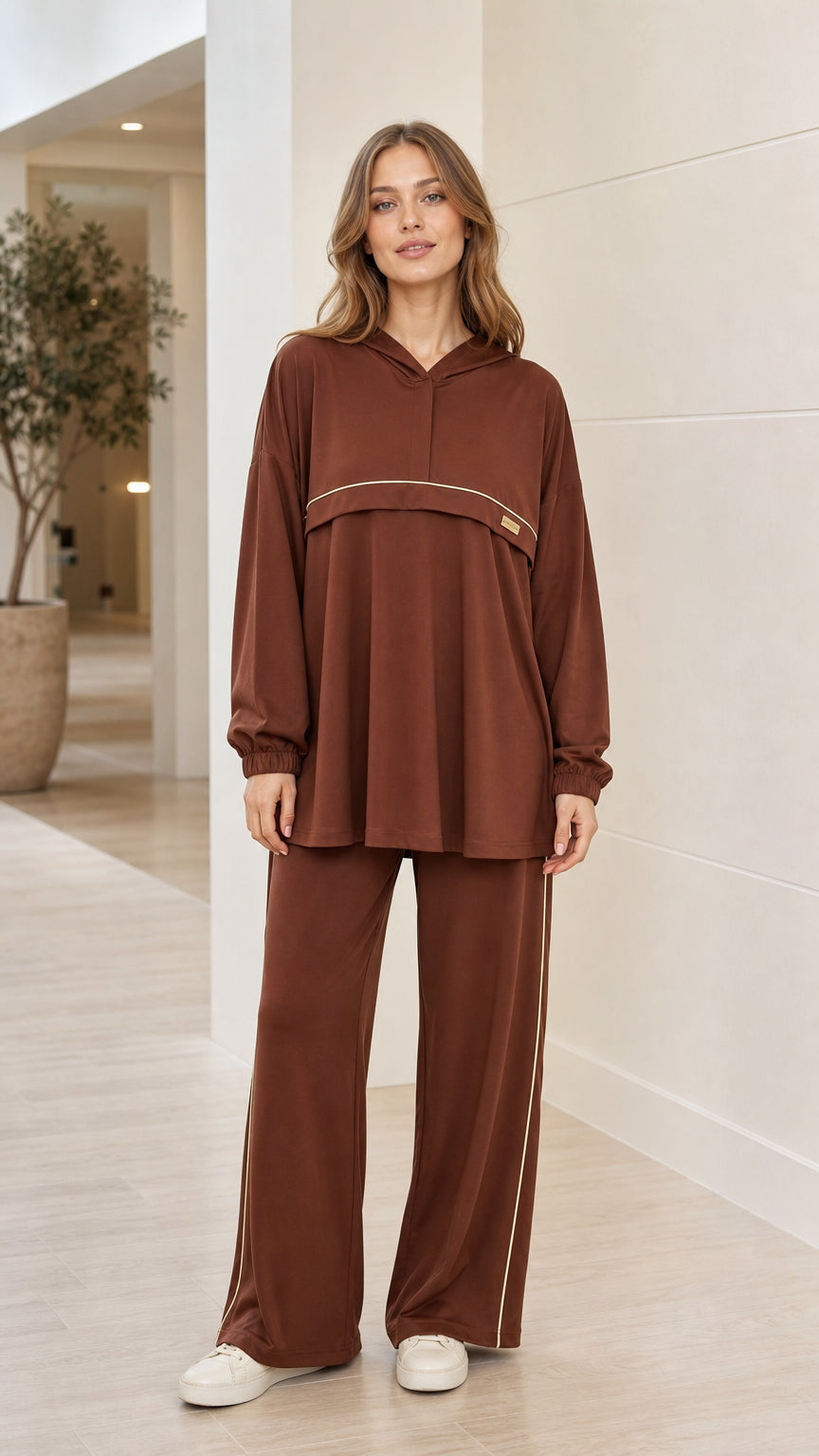 Front view of woman wearing brown hooded tunic top and wide-leg matching pants set