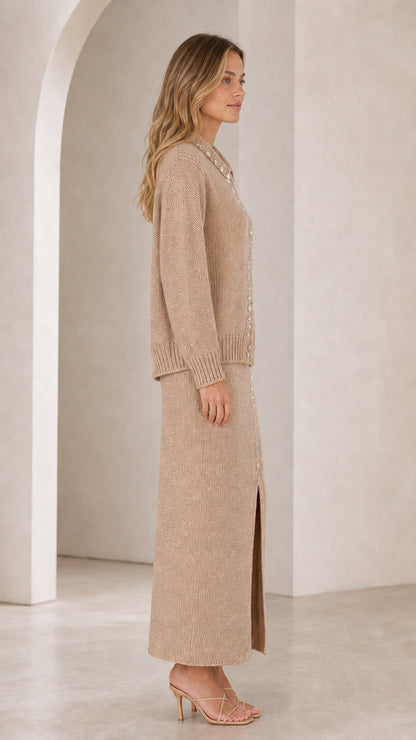 Side profile view of woman wearing beige knit two-piece cardigan and maxi skirt set