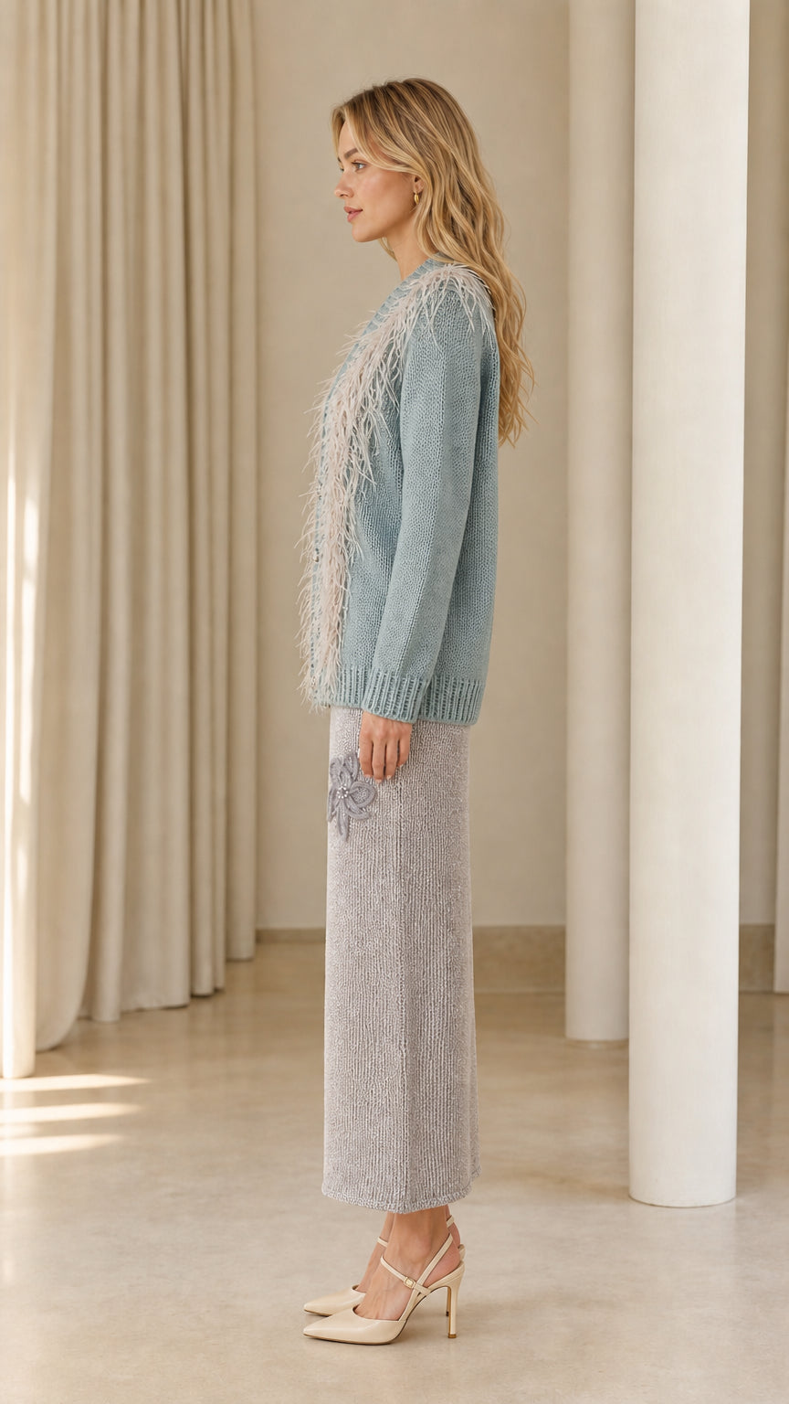 Side profile view of dusty blue feather trim cardigan sweater