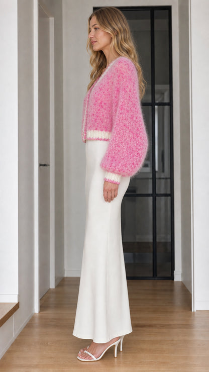 Side profile of pink fluffy cardigan with voluminous balloon sleeves