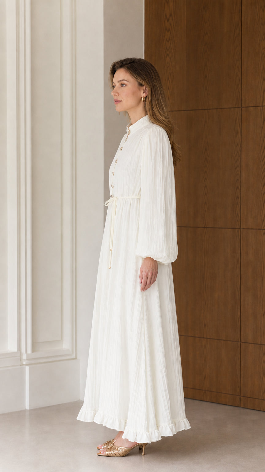 Side profile view of the Cream White textured pleated maxi dress showcasing fluid drape and sleeve volume