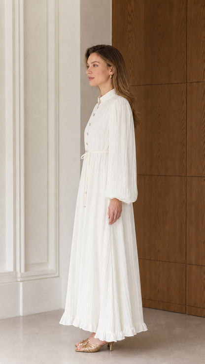 Side profile view of the Cream White textured pleated maxi dress showcasing fluid drape and sleeve volume