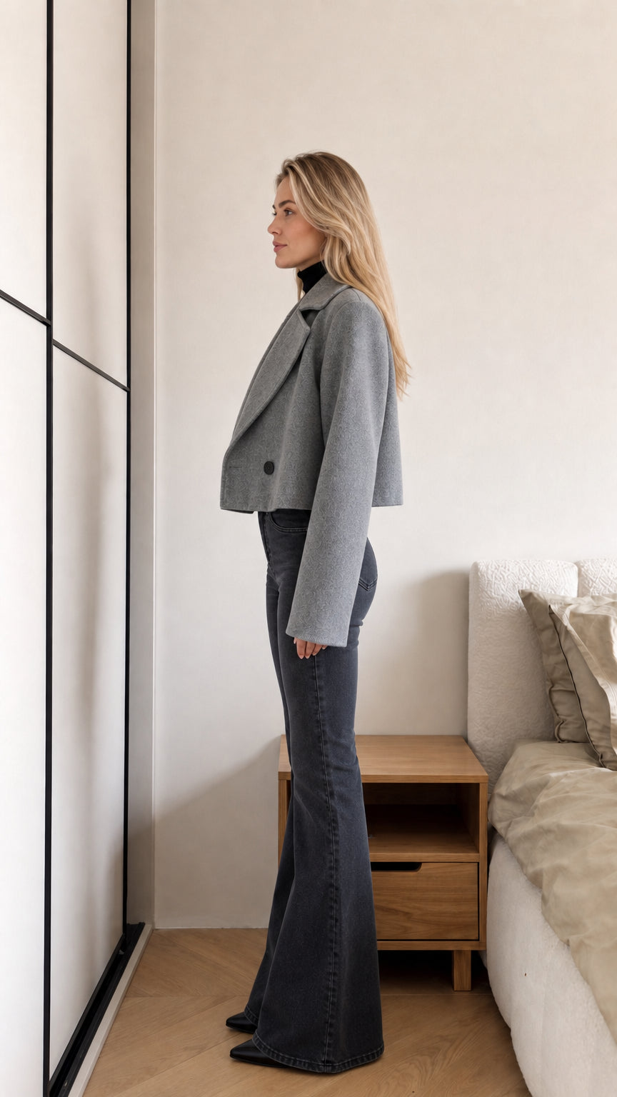 Side view of model wearing grey cropped jacket showing relaxed boxy fit and sleeve length