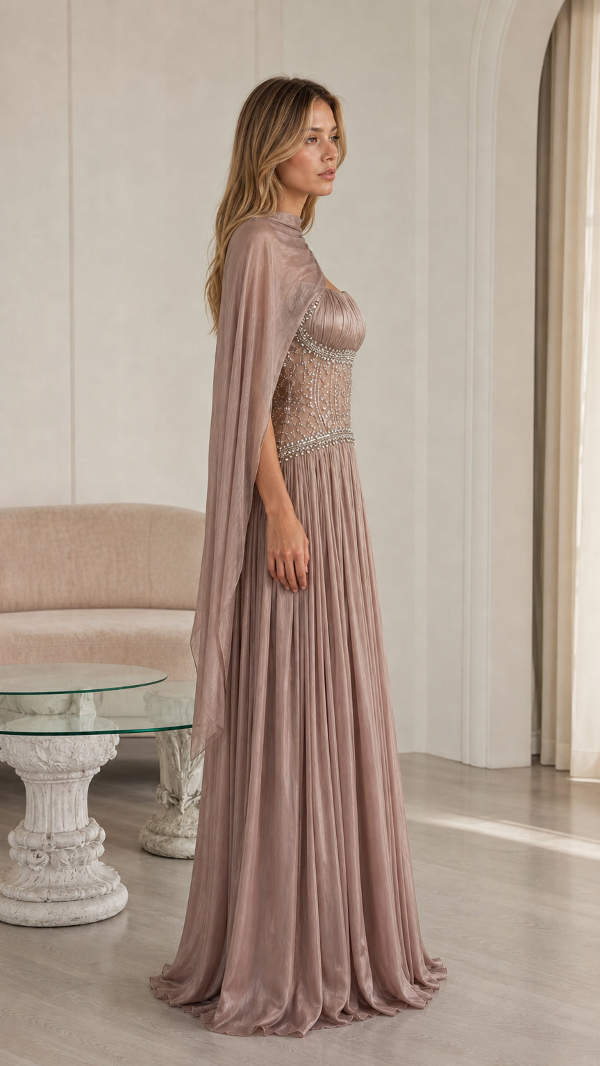 Side view of dusty mauve formal maxi gown showing pleated fabric and trailing shoulder cape