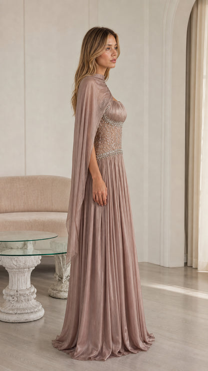 Side view of dusty mauve formal maxi gown showing pleated fabric and trailing shoulder cape