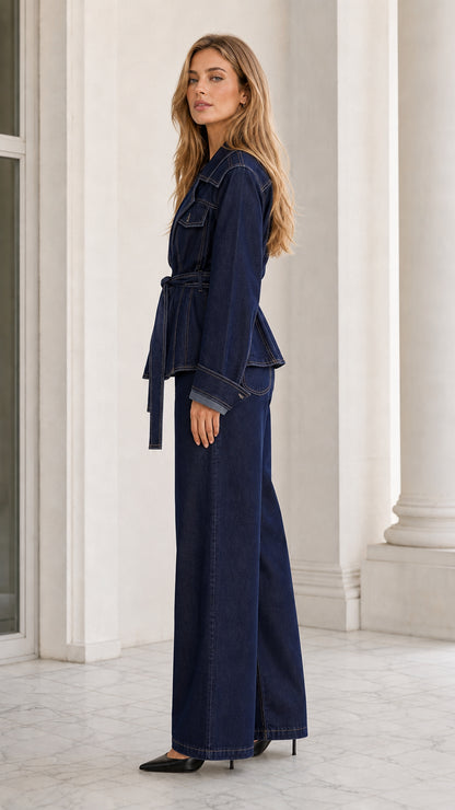 Side angle view of dark blue belted denim two-piece suit with contrast stitching