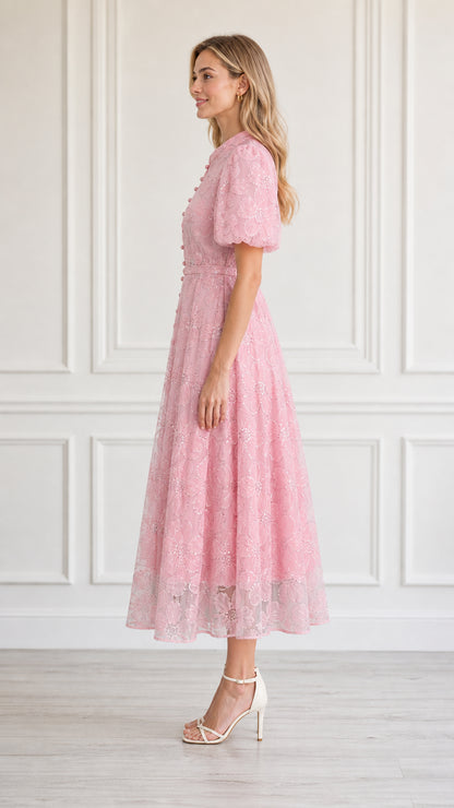Side profile view of model in pink midi dress