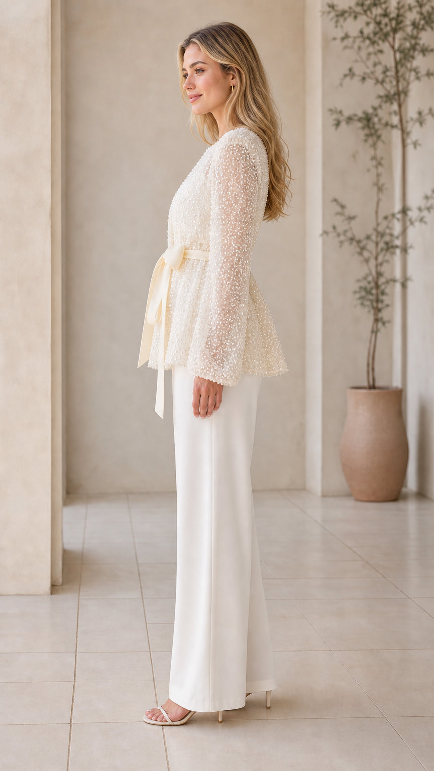 Side profile view of champagne long-sleeve sequin belted jacket top