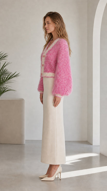 Side profile of model wearing pink fuzzy button-up cardigan