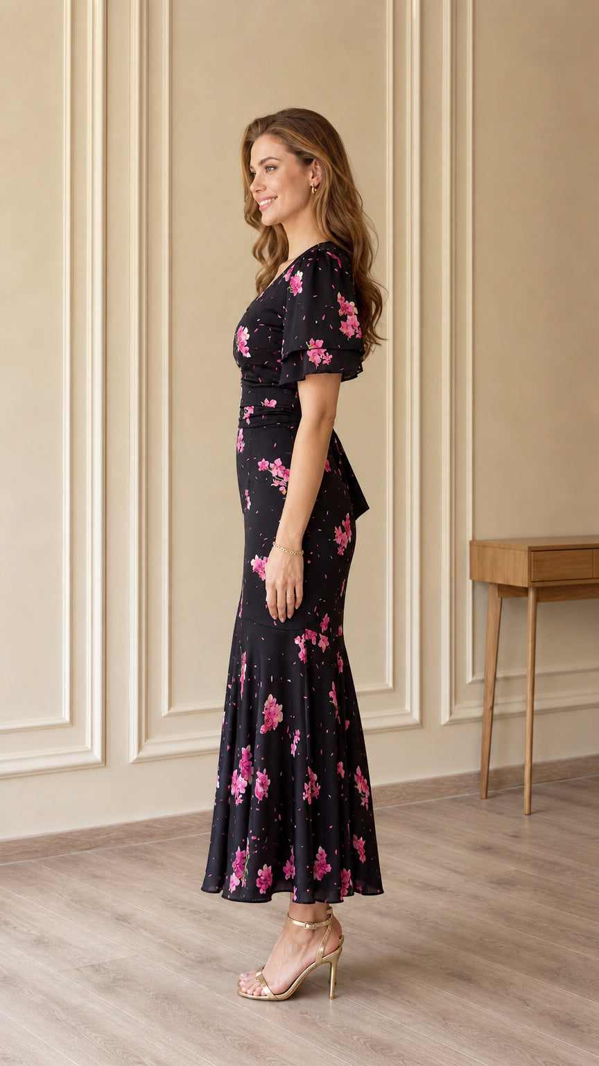 Side profile of black floral midi dress showing slim fit and mermaid hem