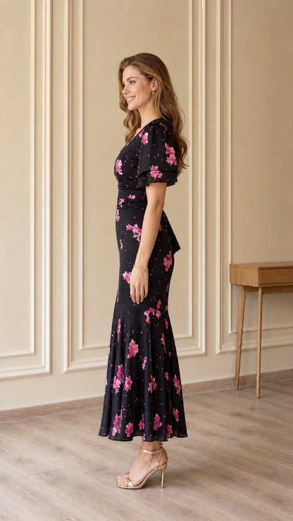 Side profile of black floral midi dress showing slim fit and mermaid hem