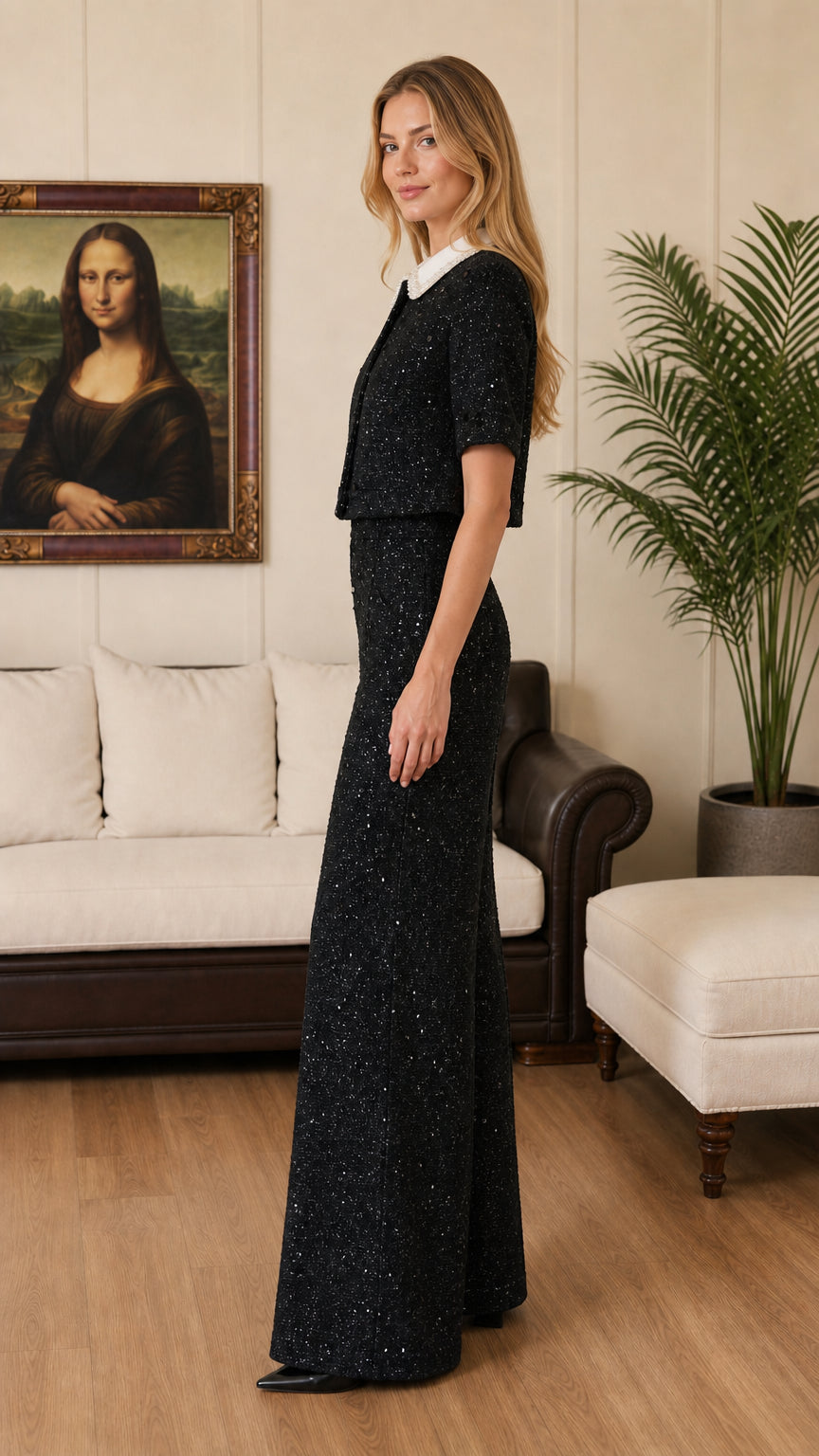 Side profile view of black tweed matching top and high-waisted trousers