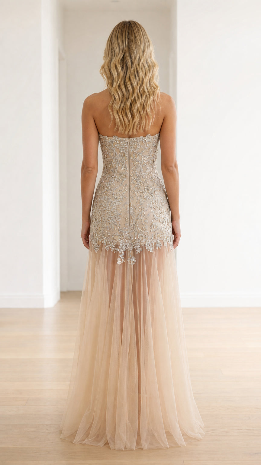Champagne strapless formal gown back view showing fitted bodice and tulle drape