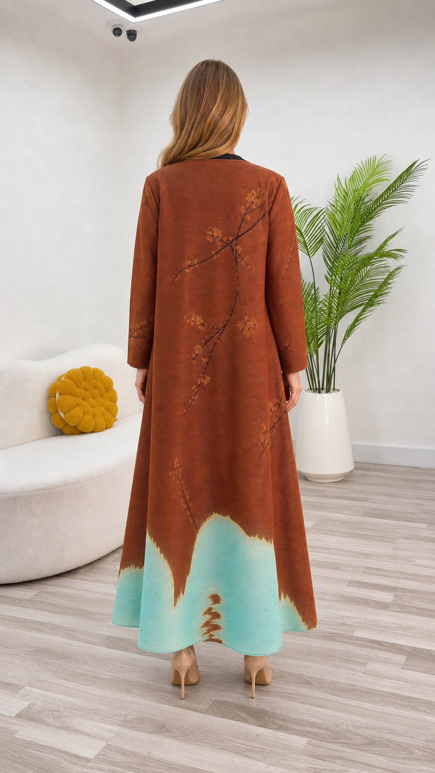 Back view of rust brown floral maxi coat showing color block hemline