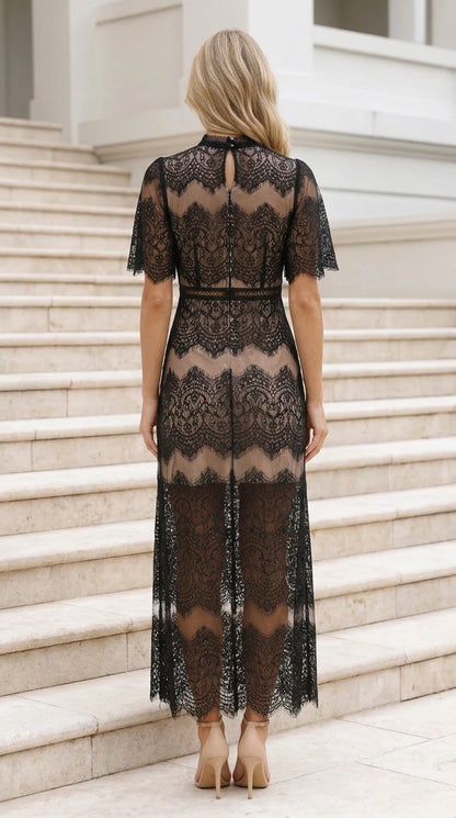 Back view of black lace maxi dress showing keyhole detail and fitted silhouette
