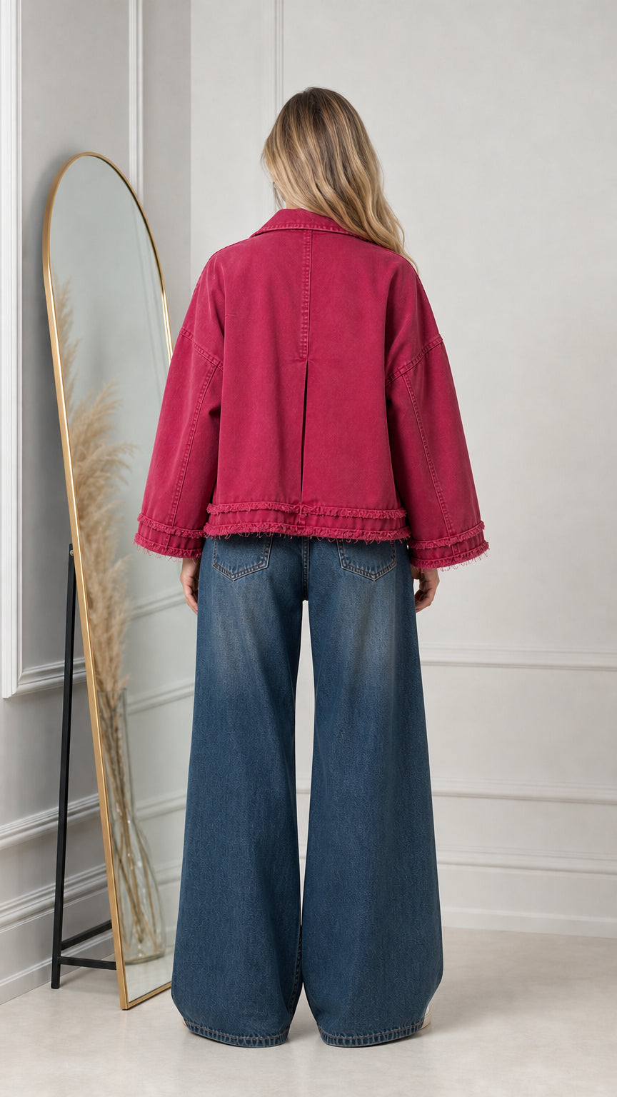 Back view of magenta cropped jacket highlighting back inverted pleat and raw hem