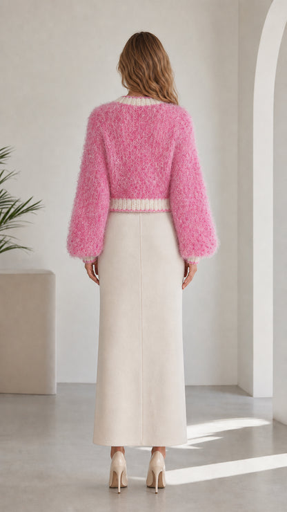 Back view of model in cropped pink fuzzy knit cardigan