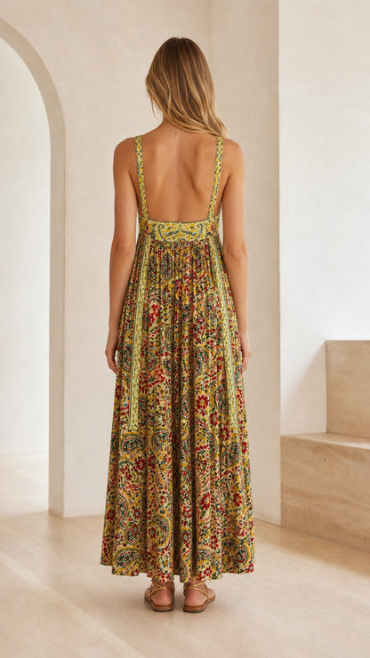 Back view of model showing open back design of yellow boho maxi dress