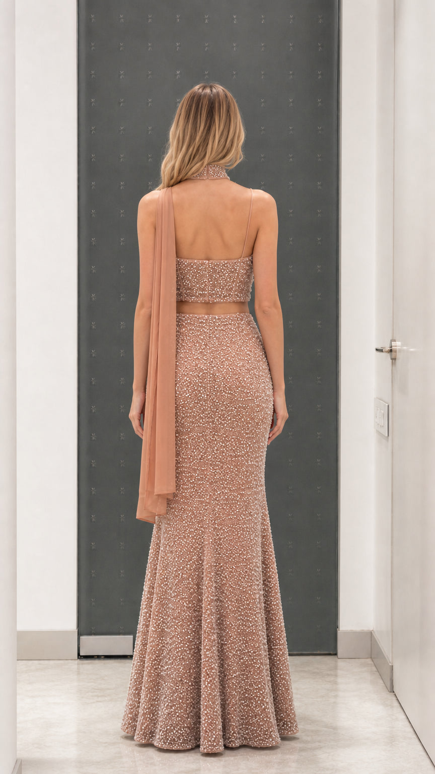 Back view of dusty rose pearl-embellished crop top and maxi skirt set with neck drape
