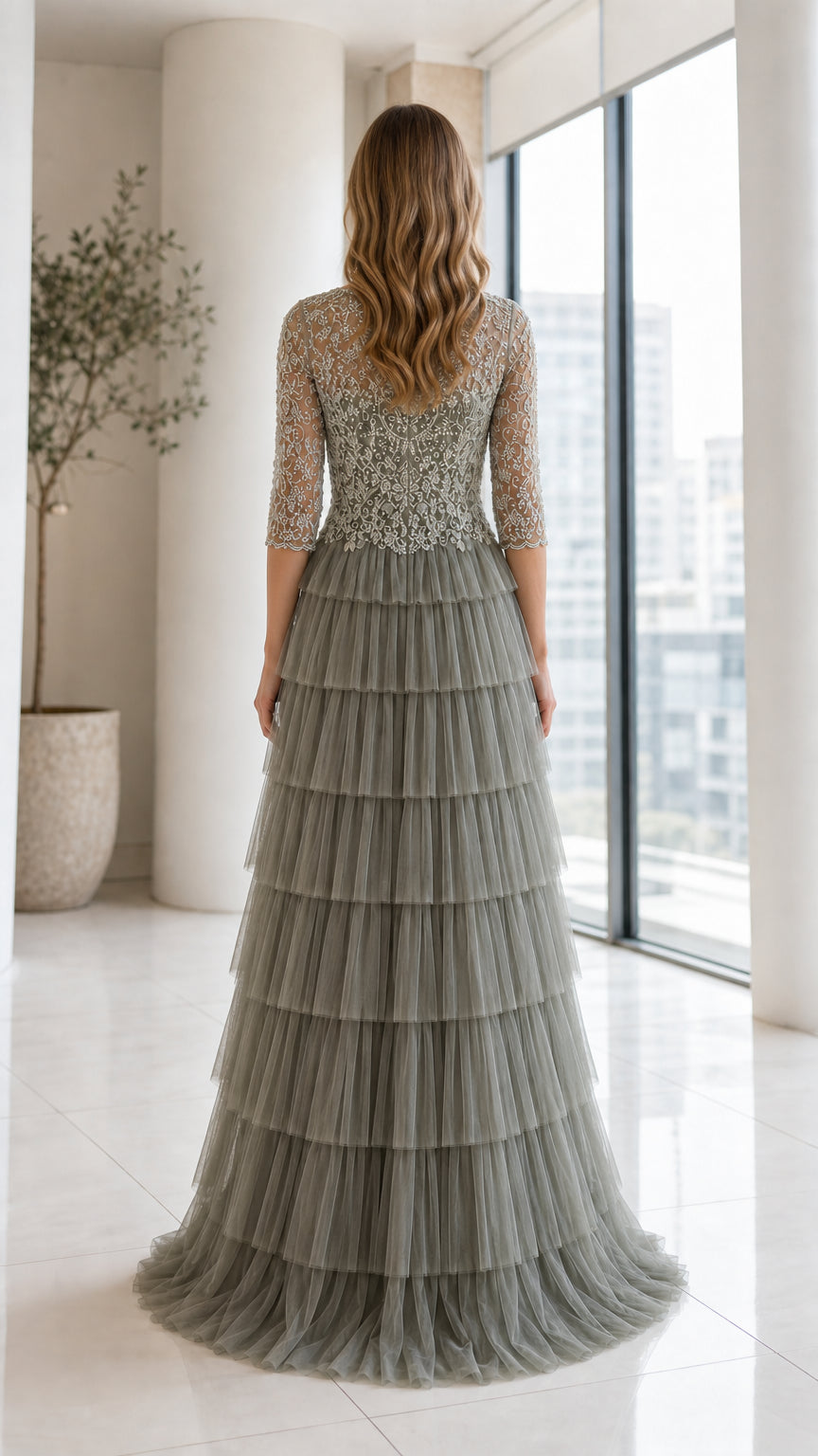 Back view of model wearing Sage Green tiered tulle evening dress