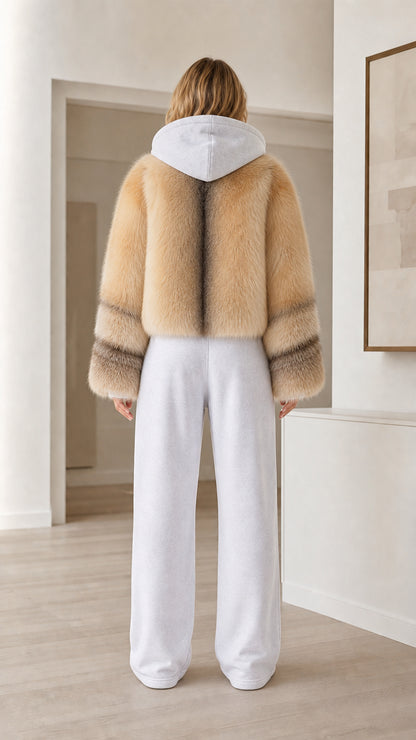 Back view of model wearing camel cropped faux fur jacket with hood