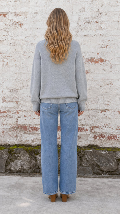 Back view of model wearing heather grey relaxed knit pullover