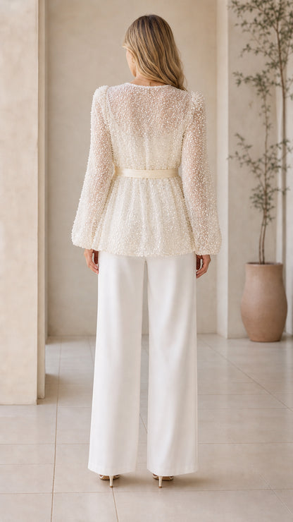 Back view of champagne sequin peplum jacket with tie waist sash