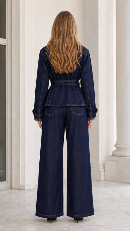 Back view of model wearing dark blue belted denim jacket and wide-leg pants