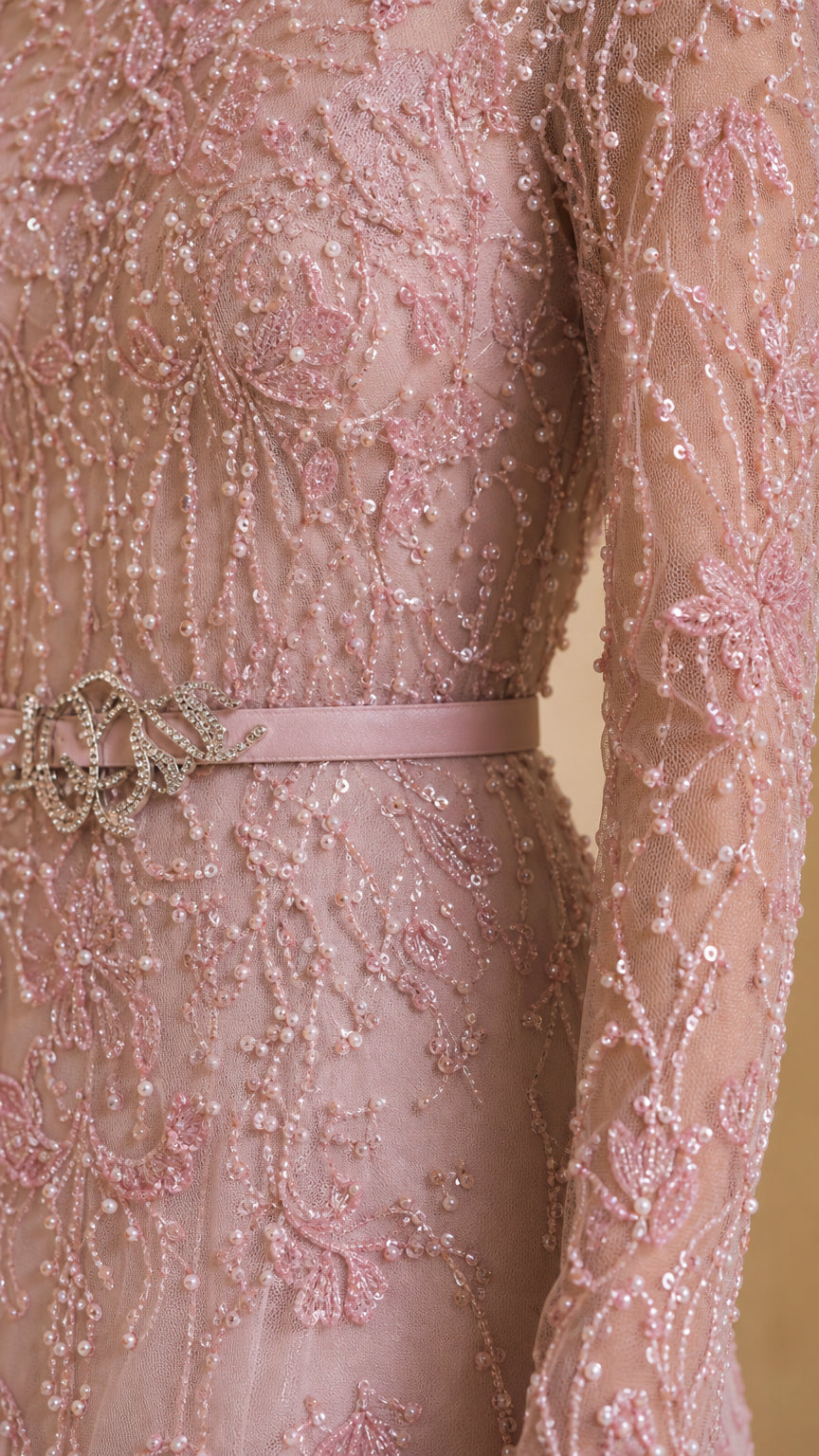 Close-up detail of blush pink sequin lace fabric and embellished waist belt