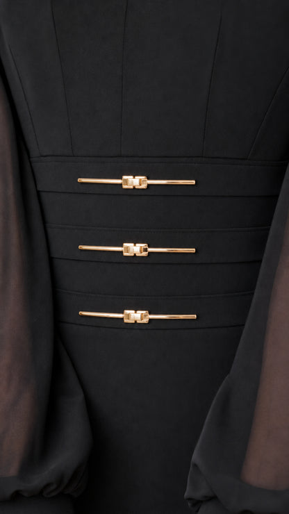 Close-up detail of high-waist panel with three gold-toned metallic bar accents