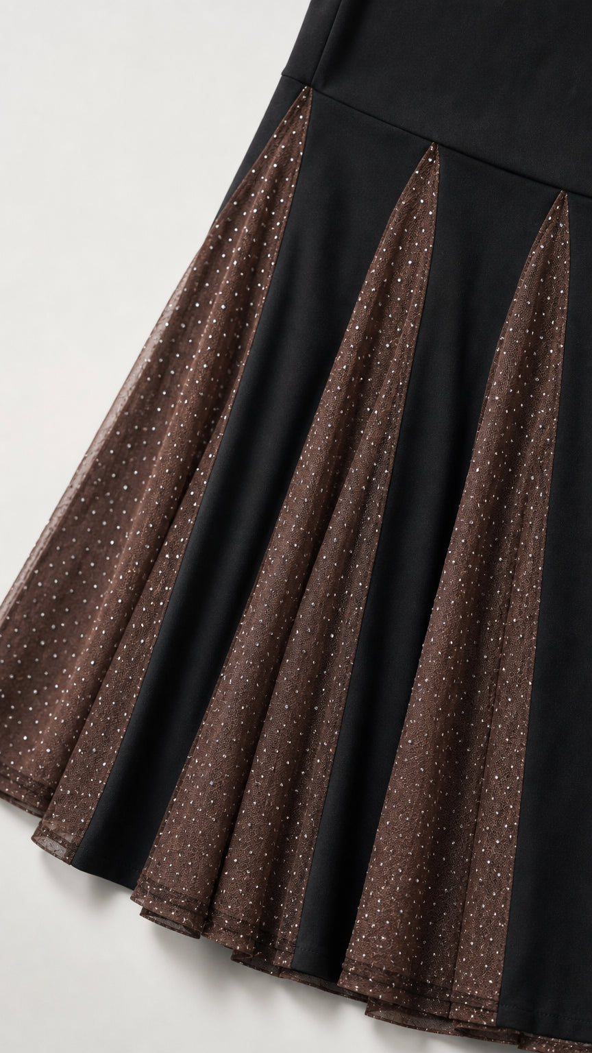 Close-up of black gown skirt showing pleated sparkling mesh godet insets