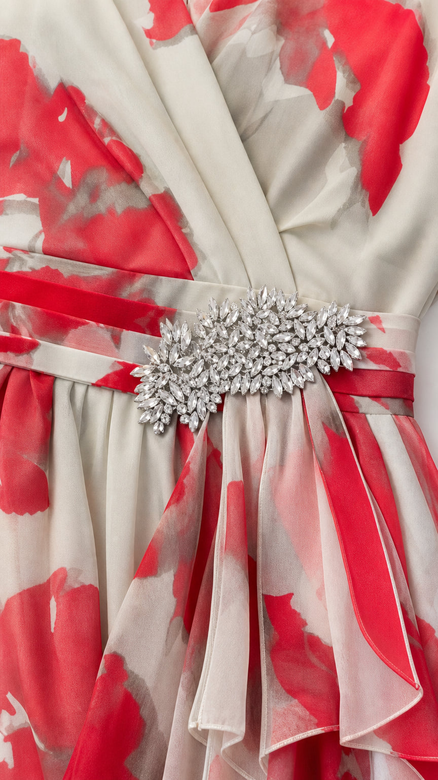 Close-up detail of crystal rhinestone waist brooch and pleated fabric drape