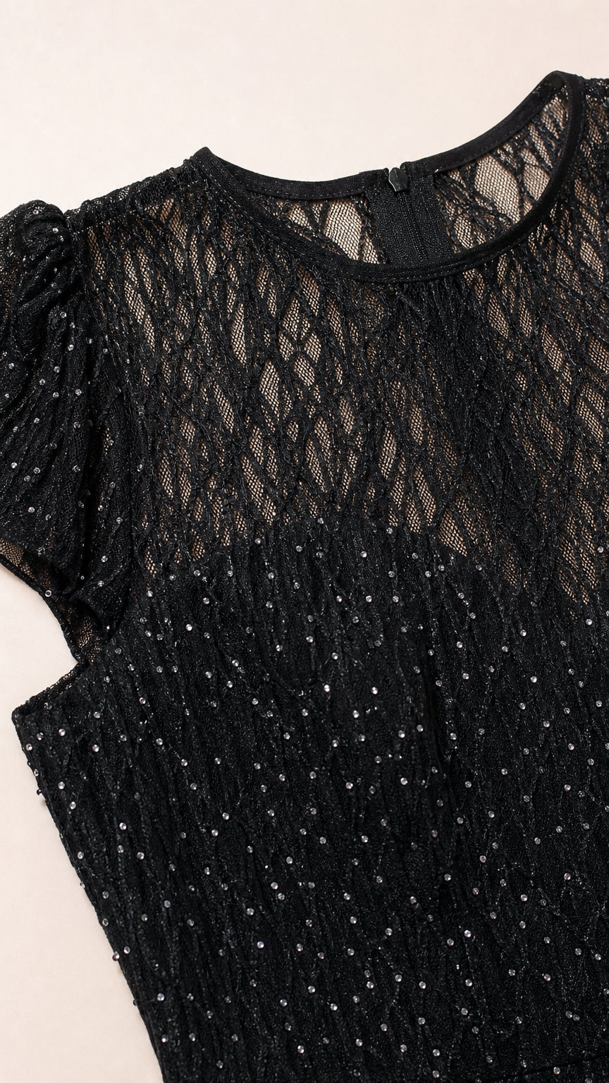 Close-up of black sheer lace mesh neckline with shimmer texture