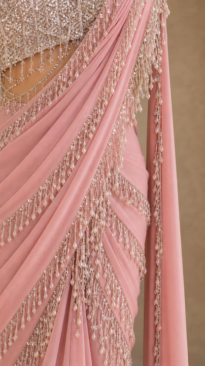 Close-up detail of beaded fringe trim and pleated chiffon drape on dusty pink gown