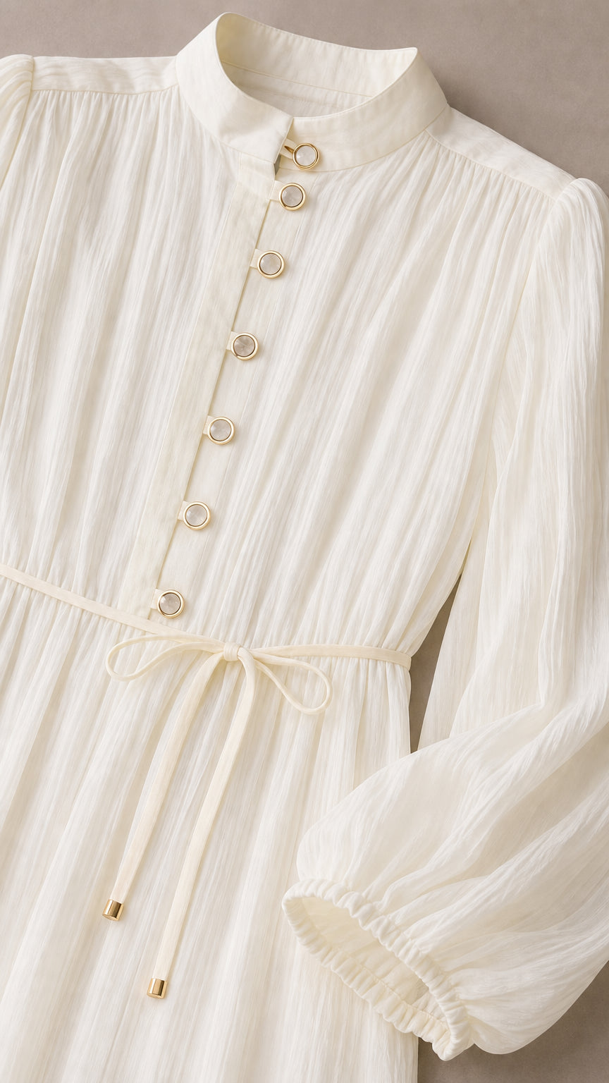 Close-up detail of the Cream White dress showing the mandarin collar, metallic ring buttons, and tie string waist