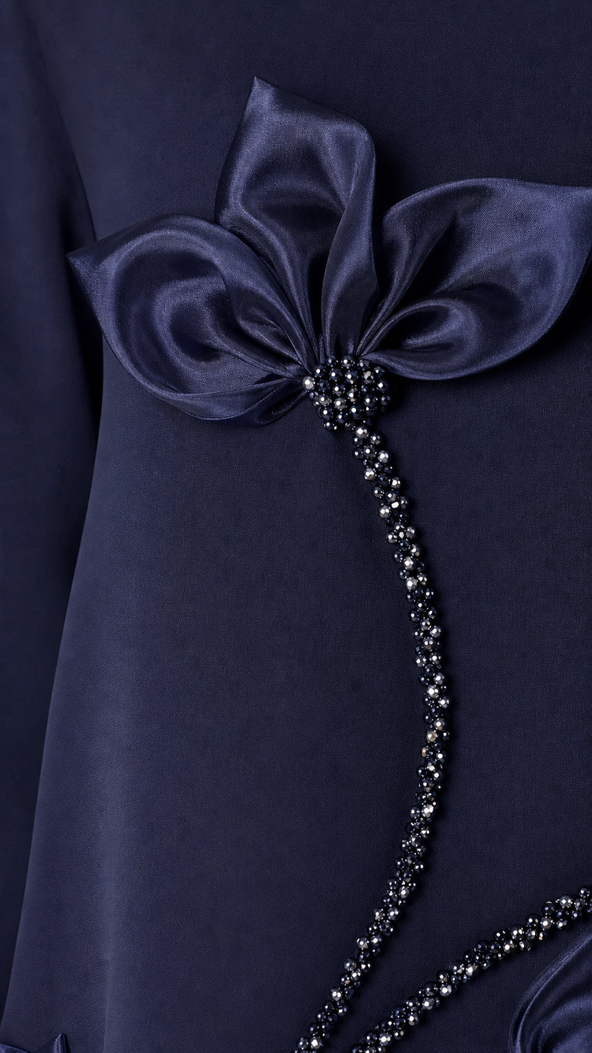 Close-up detail of 3D satin floral applique and bead embellishment