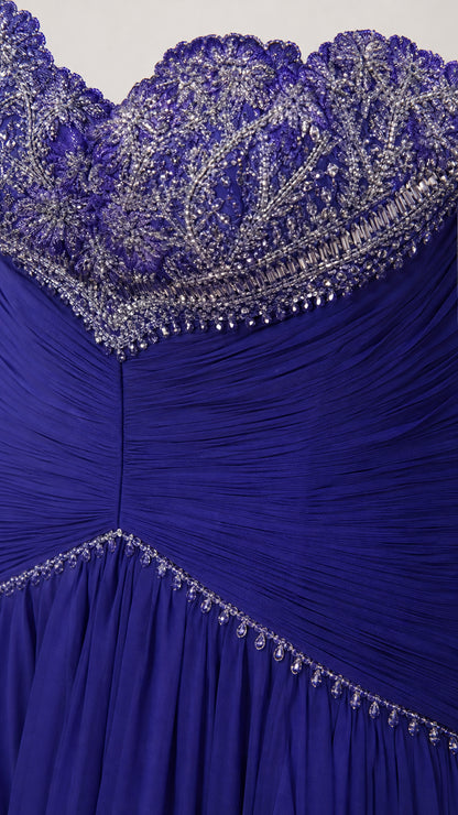 Close-up detail of intricate crystal beadwork on sweetheart neckline and pleated bodice