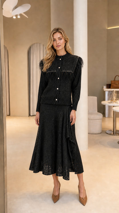 Full-length view of Black feather trim knit cardigan and ruffled midi skirt set