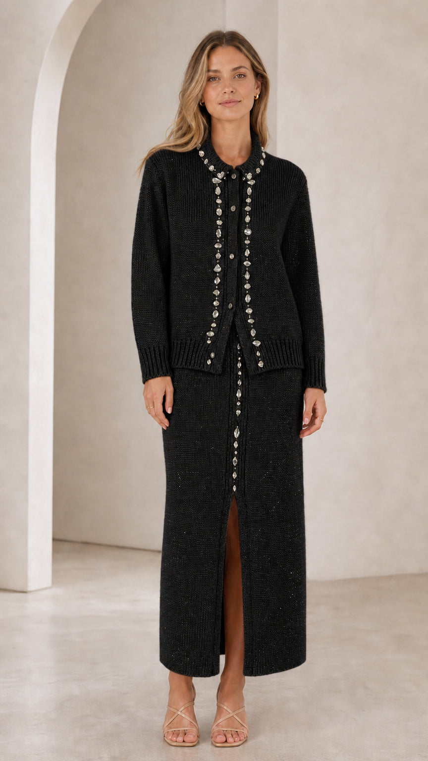 Front view of woman wearing black rhinestone-embellished knit cardigan and maxi skirt set