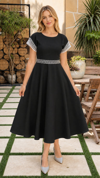 Model wearing classic black short sleeve crochet trim A-line midi dress