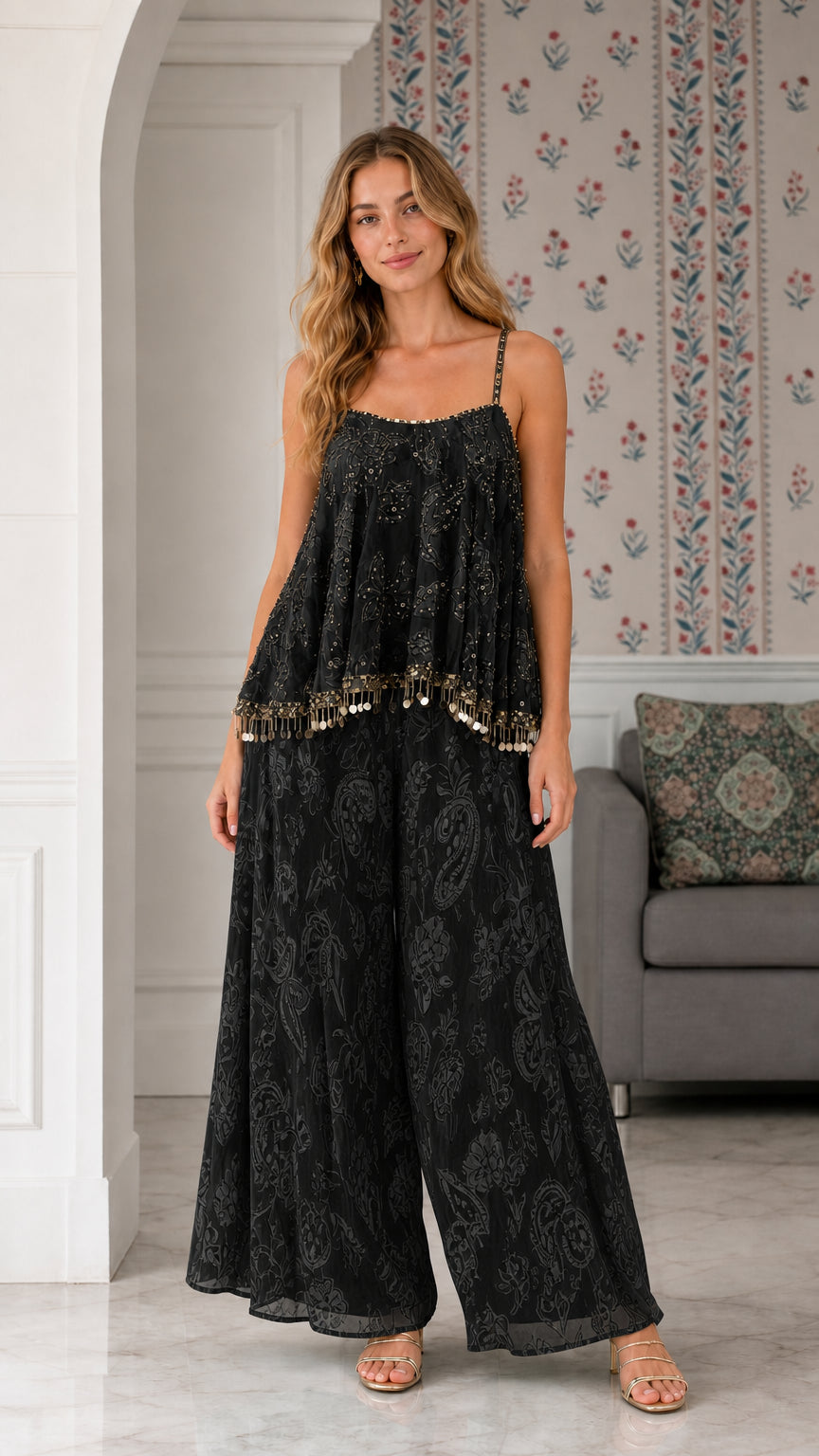Model wearing black sequin embroidered cami and palazzo pant two-piece set