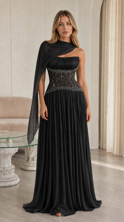 Front view of black pleated chiffon evening gown with beaded corset waist and drape