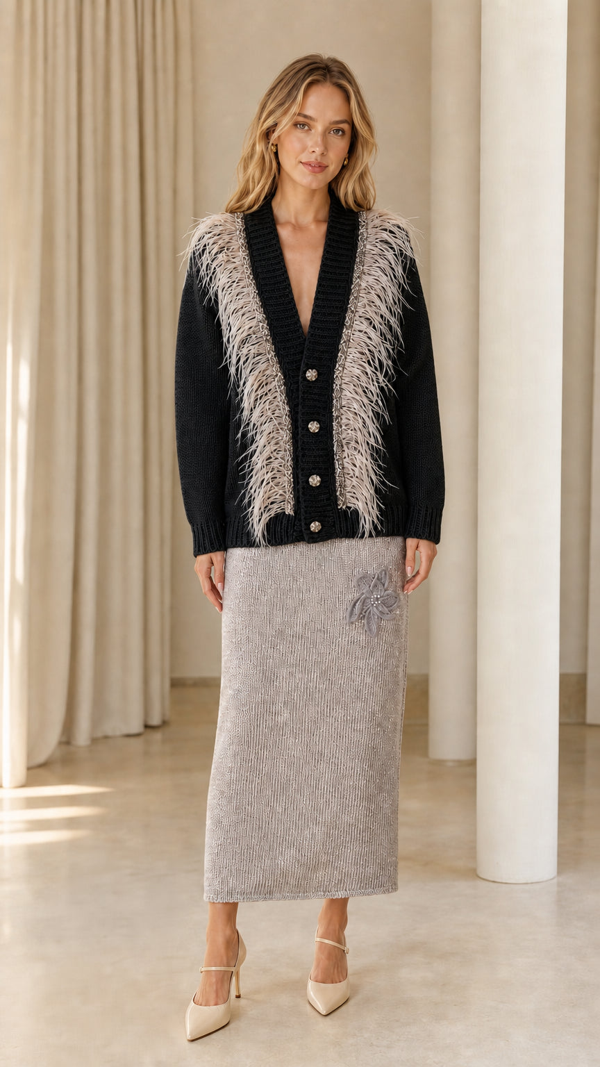 Front view of woman wearing black feather trim cardigan sweater