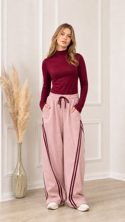 Full front view of dusty pink wide-leg sweatpants with burgundy side stripes