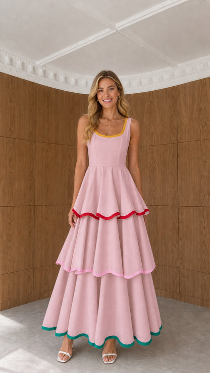 Model wearing pink sleeveless tiered maxi dress with contrast edge piping